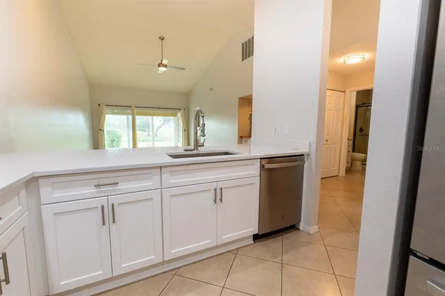 a spacious bathroom with a granite countertop sink and mirror