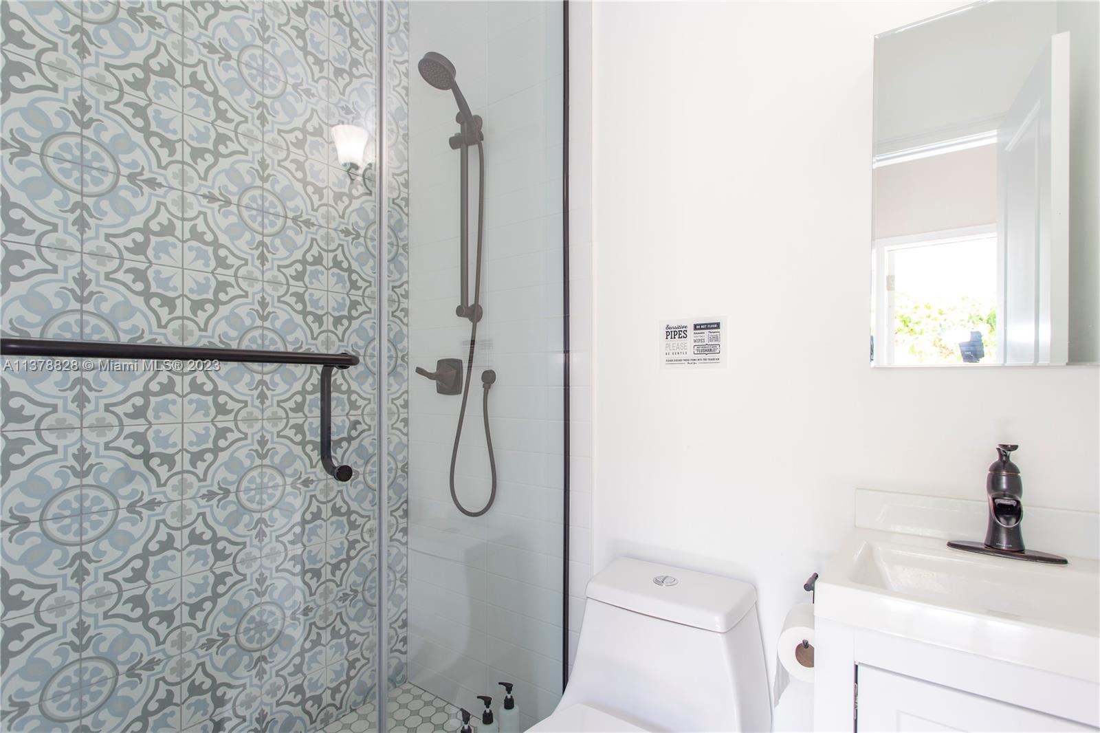 3371 Southwest 21st Street Miami, FL 33145 - Photo 13 of 23 a bathroom with a shower a toilet and a sink