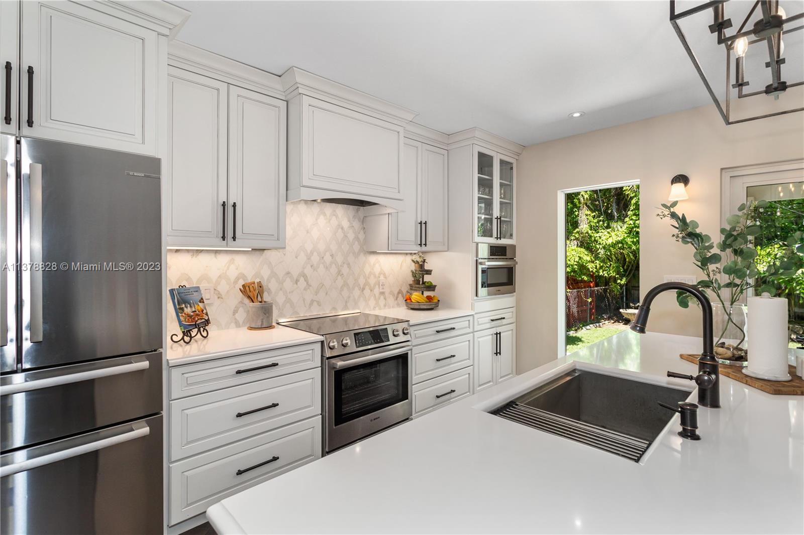 3371 Southwest 21st Street Miami, FL 33145 - Photo 15 of 23 a kitchen with a refrigerator and a stove top oven