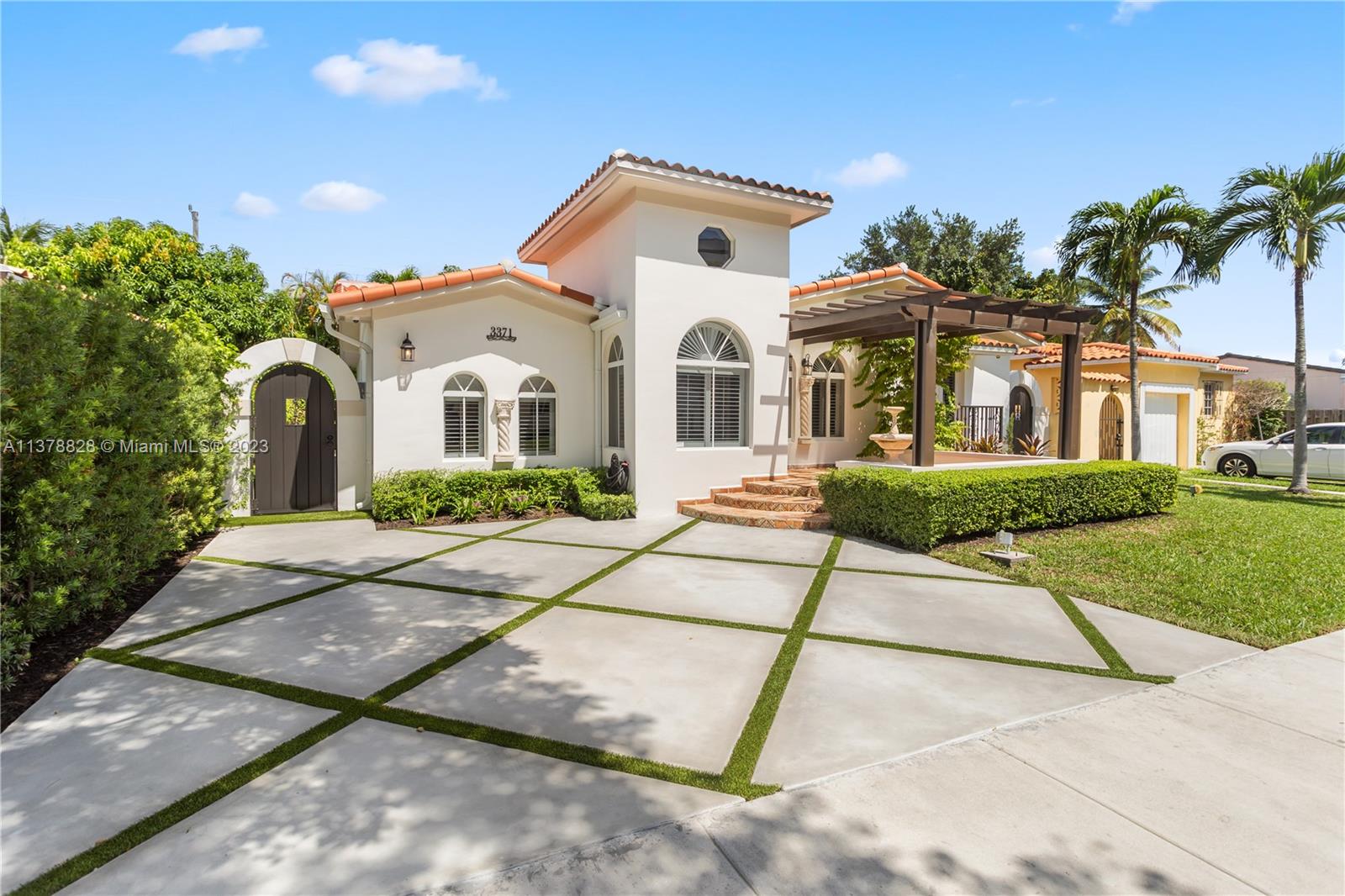 3371 Southwest 21st Street Miami, FL 33145 - Photo 22 of 23 a front view of a house with a yard and potted plants