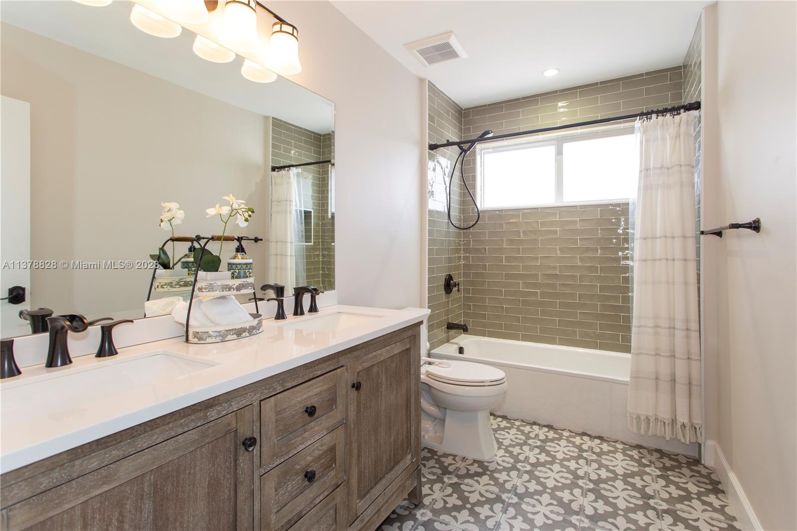 3371 Southwest 21st Street Miami, FL 33145 - Photo 7 of 23 a bathroom with a double vanity sink toilet and shower