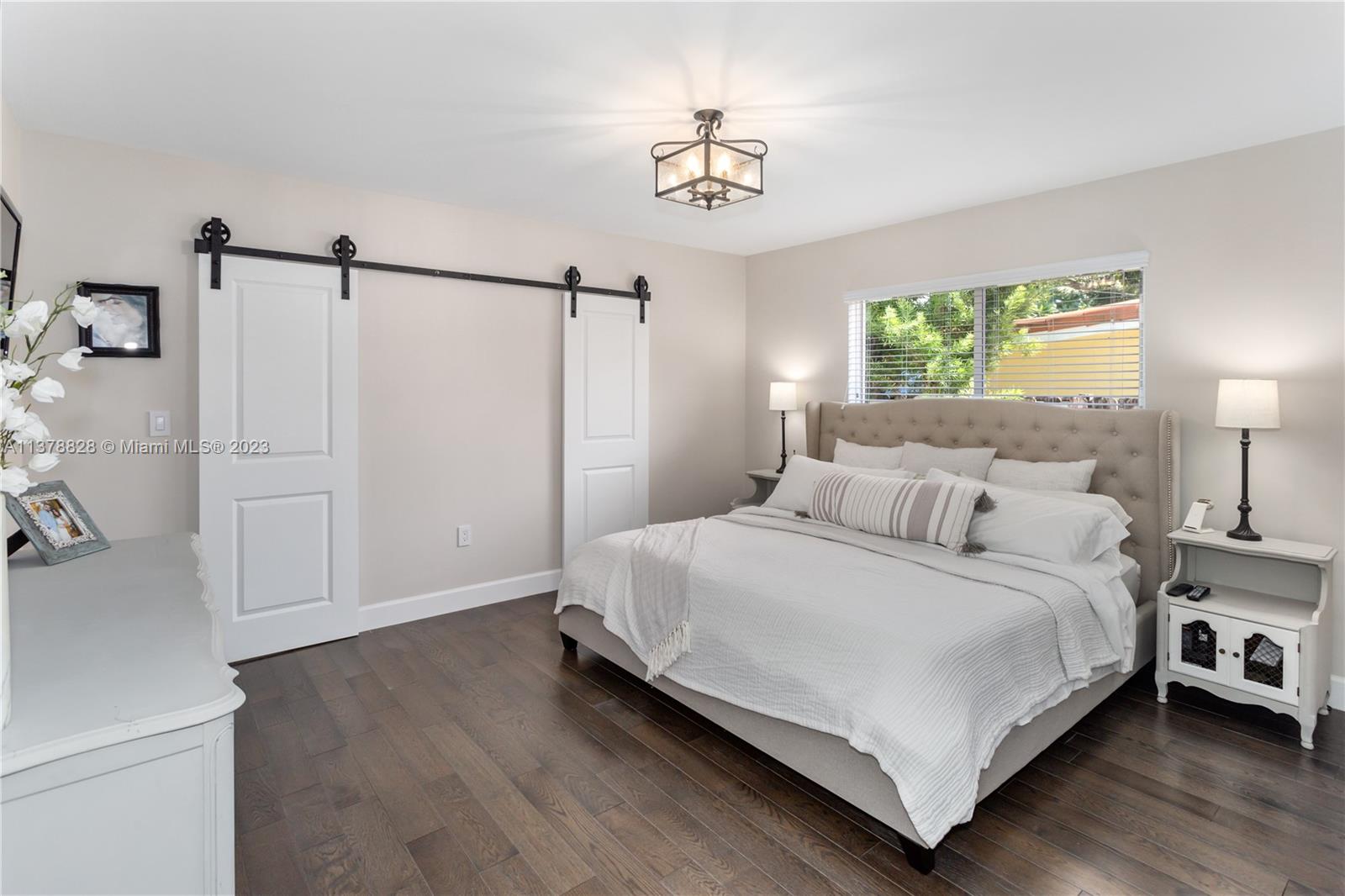 3371 Southwest 21st Street Miami, FL 33145 - Photo 8 of 23 a bedroom with a bed and a chandelier