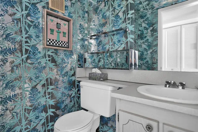 a bathroom with a toilet sink and mirror