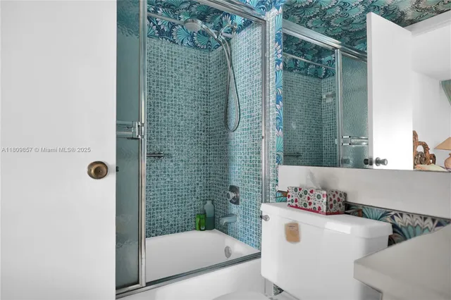 a bathroom with a shower and a sink