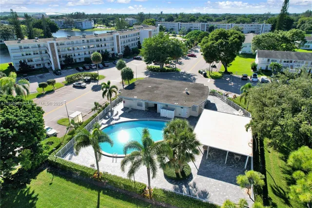 an aerial view of a house with yard swimming pool and outdoor seating