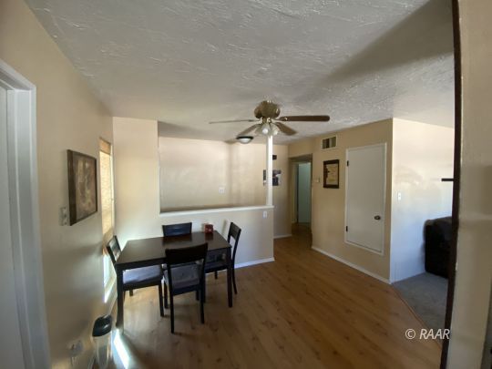 413 Karin Street Ridgecrest, CA 93555 - Photo 7 of 20 a view of a dining room with furniture and wooden floor