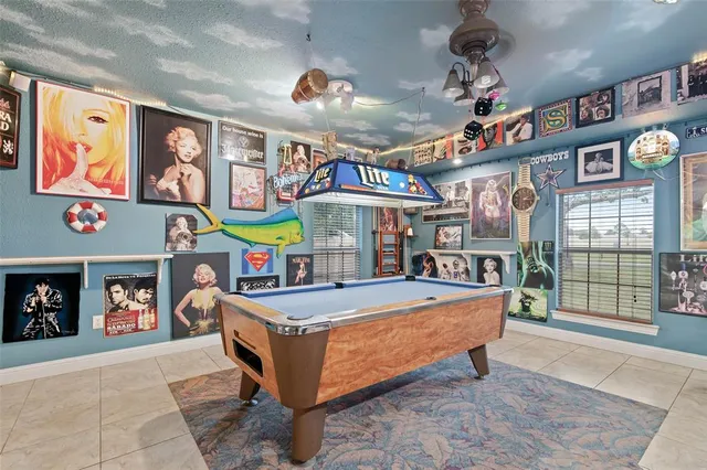 a room with lots of furniture and fan