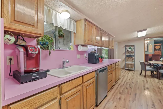 a kitchen with kitchen island granite countertop a sink and cabinets