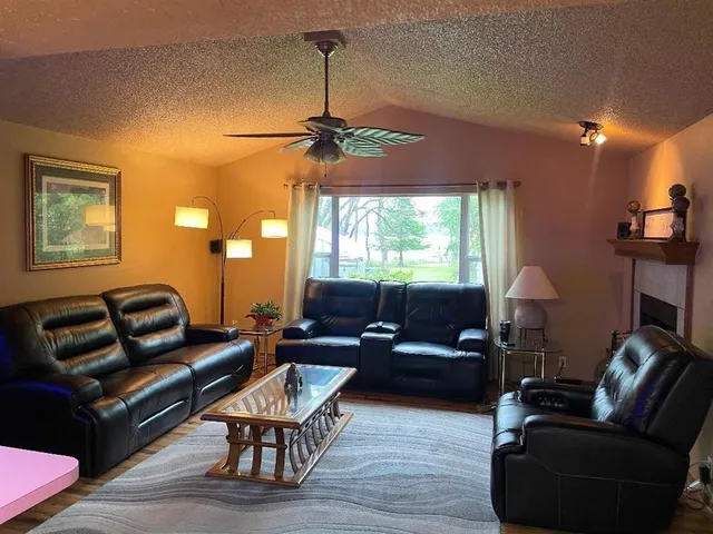 a living room with furniture a window and a flat screen tv