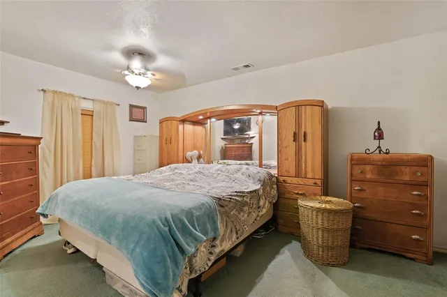 a bedroom with a bed and a mirror