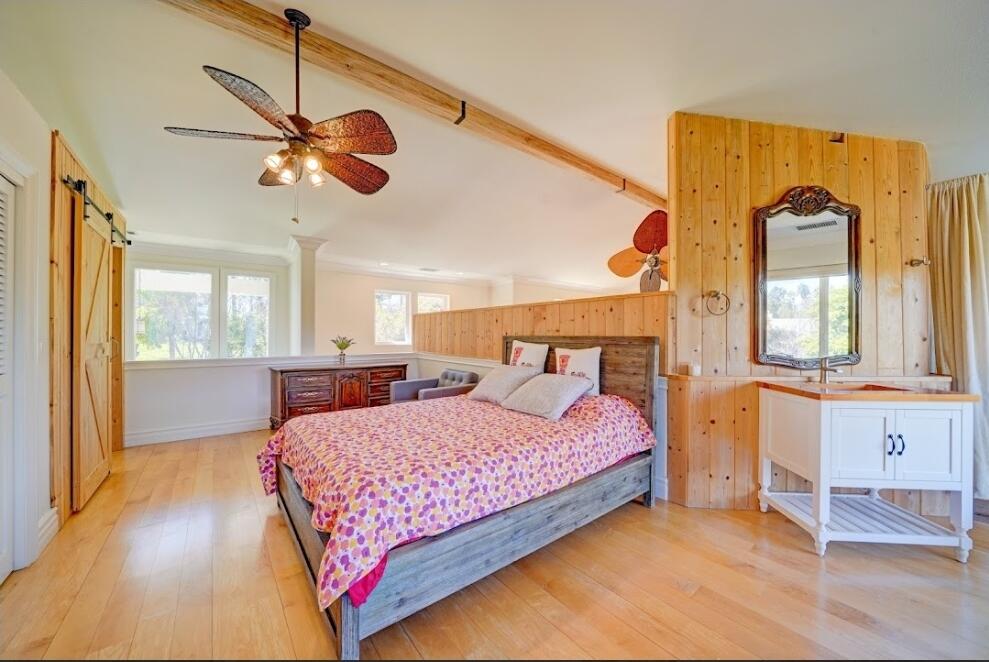 1377 Knoll Road Redlands, CA 92373 - Photo 8 of 28 a bedroom with a bed dresser and wooden floor