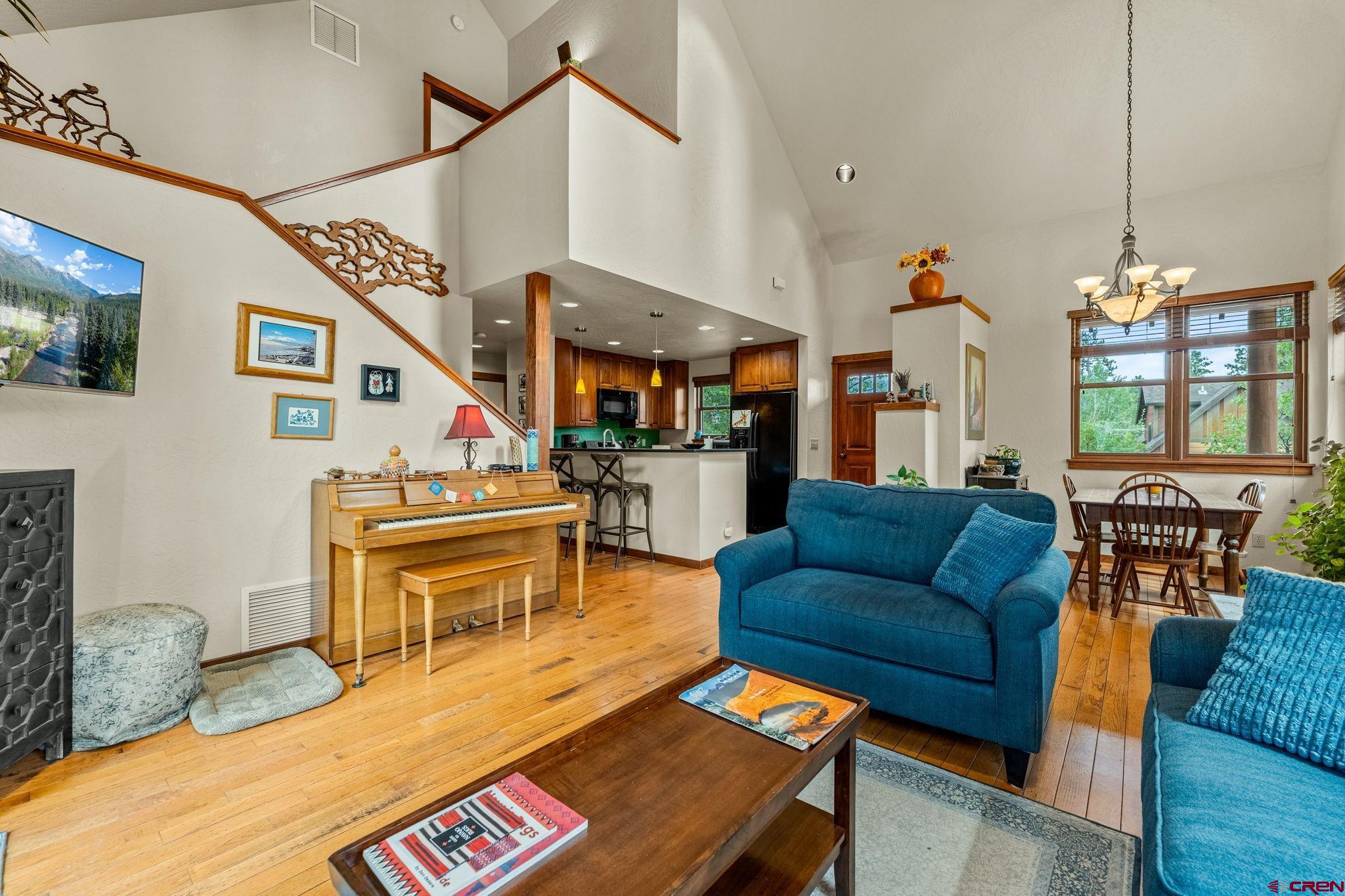 141 Red Canyon Trail, Unit E Durango, CO 81301 - Photo 5 of 42 a living room with furniture a dining table and chairs with wooden floor
