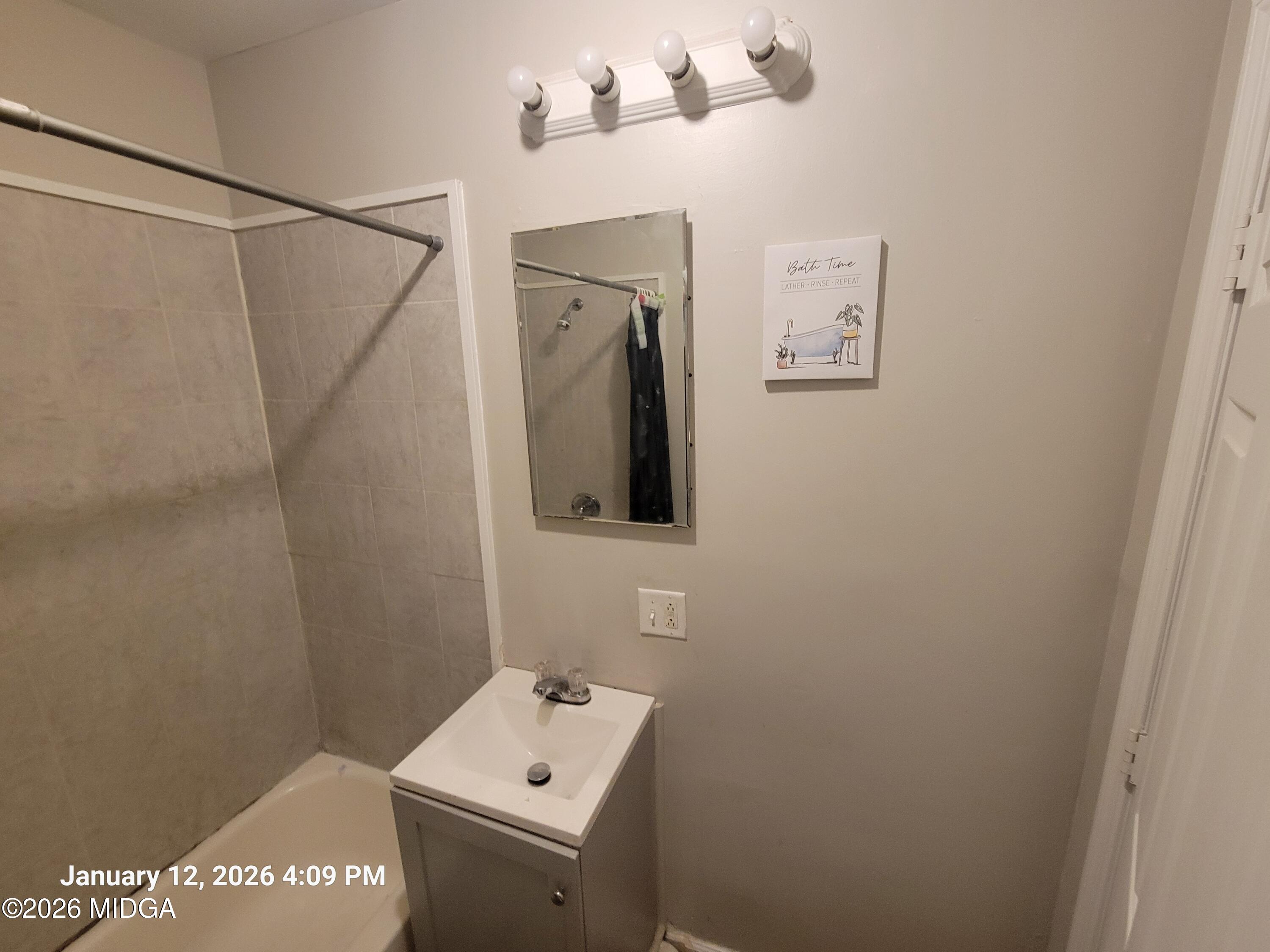 2872 Antioch Road Macon, GA 31206 - Photo 5 of 12 a bathroom with a sink and mirror