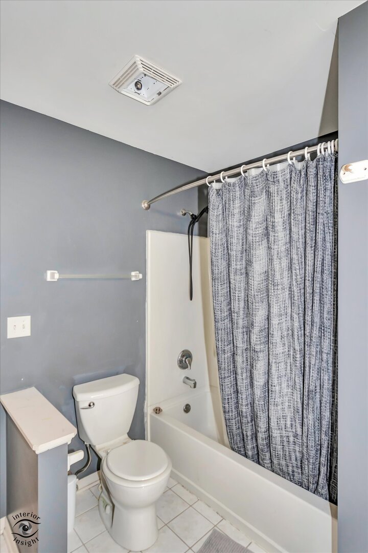 1831 South Wentworth Circle Romeoville, IL 60446 - Photo 19 of 23 a white toilet sitting next to a shower curtain