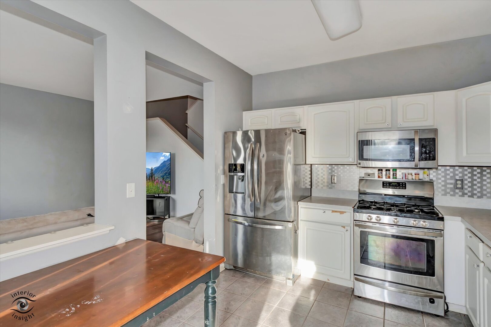1831 South Wentworth Circle Romeoville, IL 60446 - Photo 10 of 23 a kitchen with granite countertop a refrigerator stove and microwave