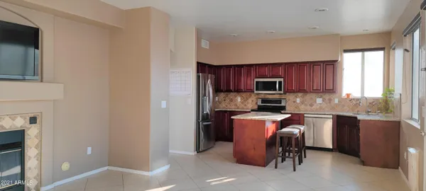 a kitchen with a refrigerator stove top oven a sink and dishwasher
