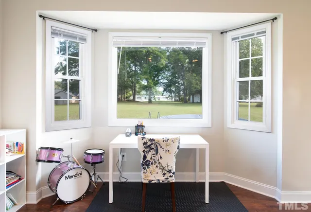 a dining room with furniture and window