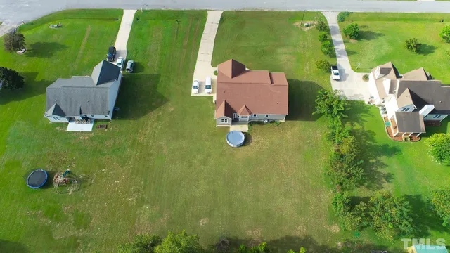 an aerial view of a house with swimming pool patio and balcony