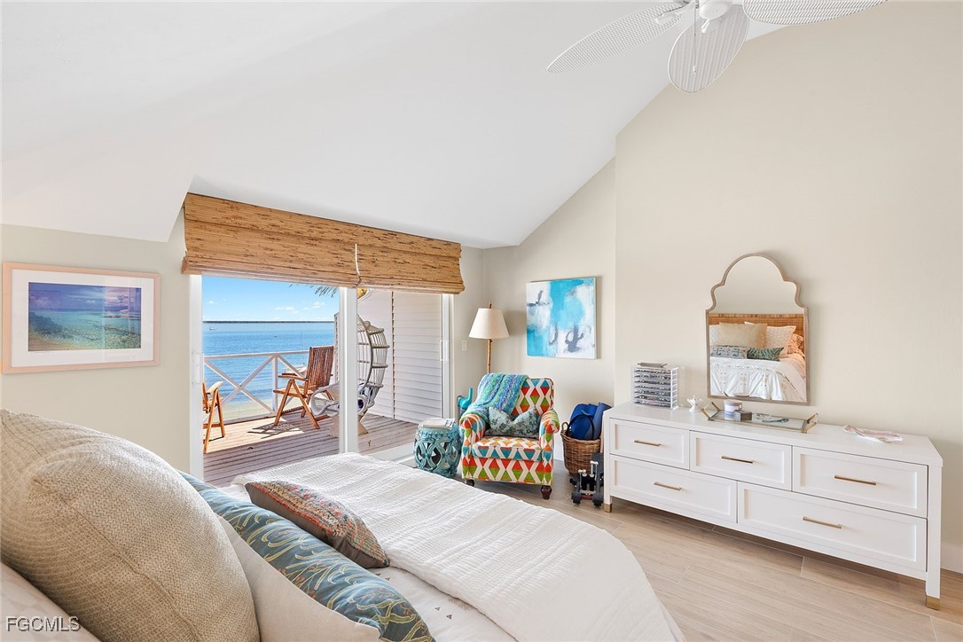 114 Useppa Island, Unit A Bokeelia, FL 33922 - Photo 19 of 44 a bedroom with furniture and a mirror
