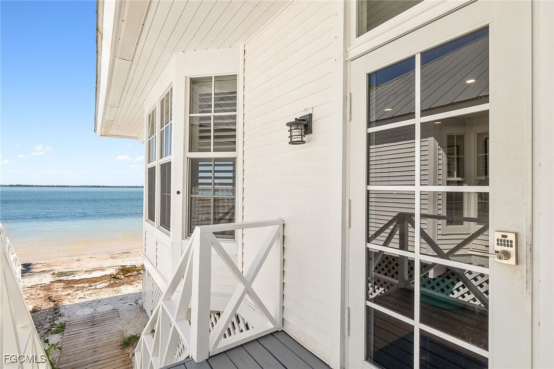114 Useppa Island, Unit A Bokeelia, FL 33922 - Photo 2 of 44 a view of a room with wooden floor and windows