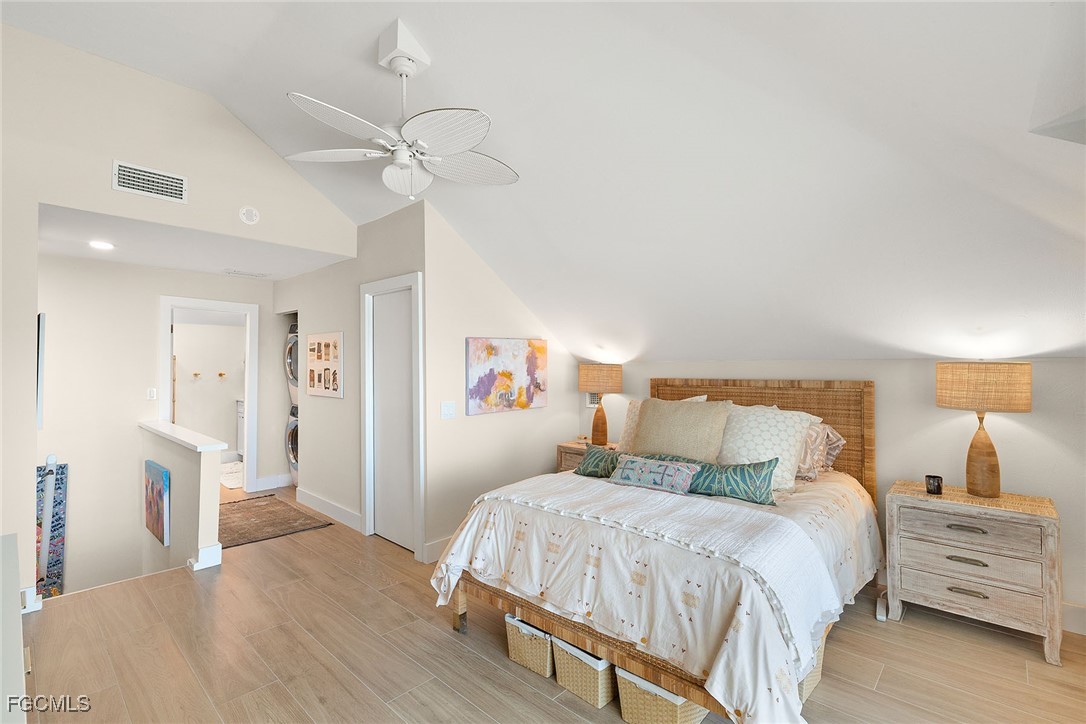 114 Useppa Island, Unit A Bokeelia, FL 33922 - Photo 21 of 44 a bed room with a bed and a chandelier