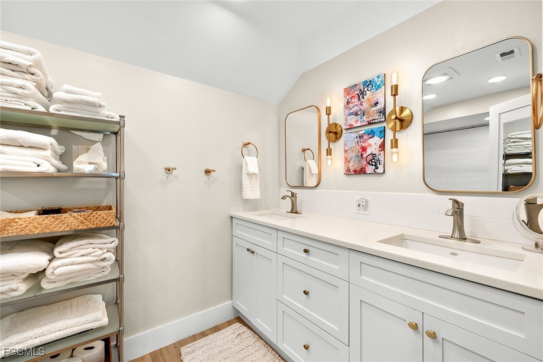 114 Useppa Island, Unit A Bokeelia, FL 33922 - Photo 22 of 44 a bathroom with a sink a vanity and a mirror