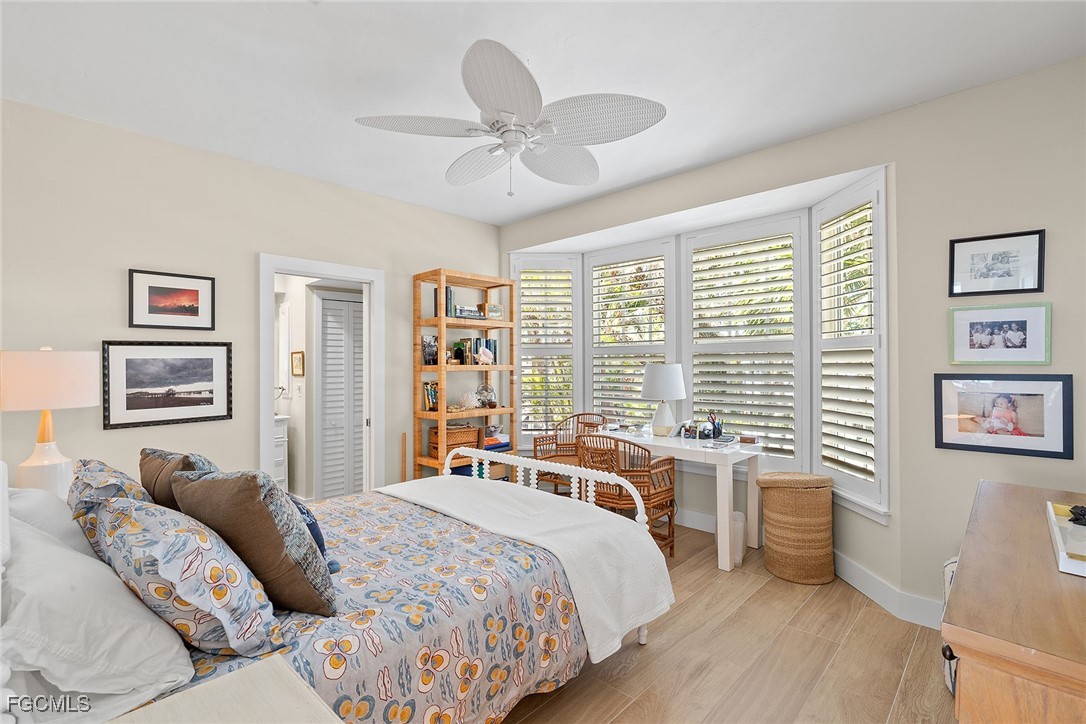 114 Useppa Island, Unit A Bokeelia, FL 33922 - Photo 24 of 44 a bedroom with a large bed and a large window
