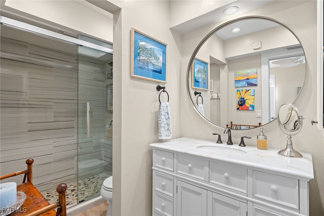 114 Useppa Island, Unit A Bokeelia, FL 33922 - Photo 25 of 44 a bathroom with a sink and a mirror