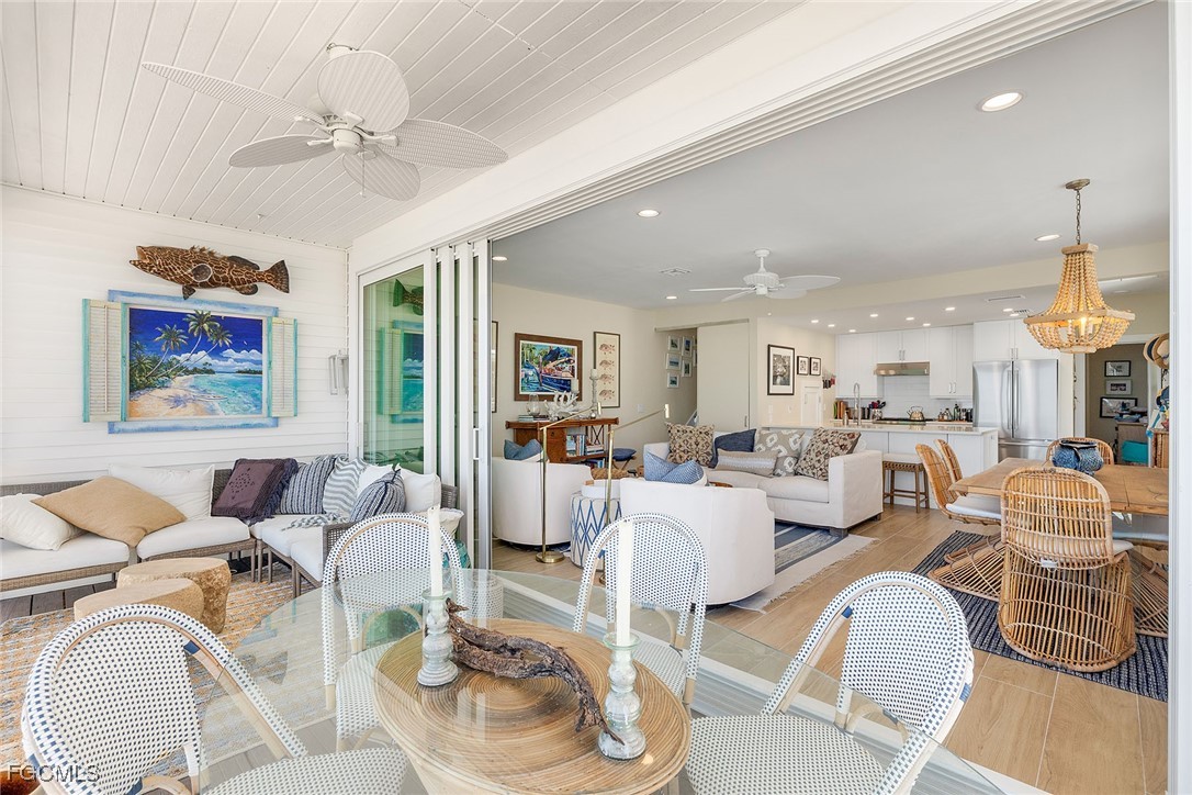 114 Useppa Island, Unit A Bokeelia, FL 33922 - Photo 29 of 44 a living room with furniture kitchen view and a chandelier