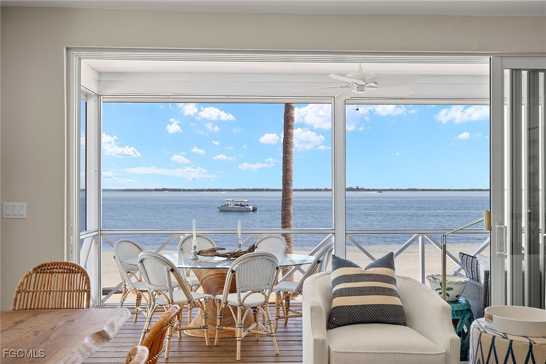 114 Useppa Island, Unit A Bokeelia, FL 33922 - Photo 30 of 44 a living room with furniture and a floor to ceiling window