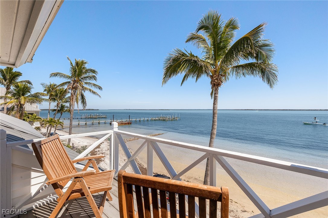 114 Useppa Island, Unit A Bokeelia, FL 33922 - Photo 34 of 44 a view of a swimming pool with a table and chairs