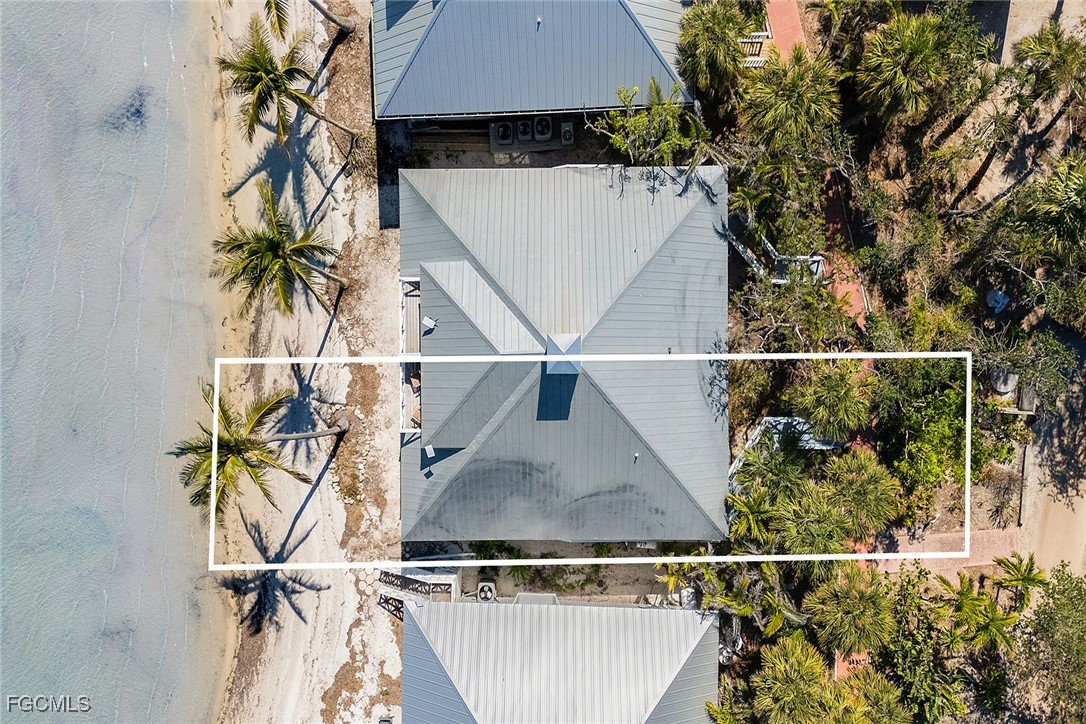 114 Useppa Island, Unit A Bokeelia, FL 33922 - Photo 39 of 44 an aerial view of a house with table and chairs