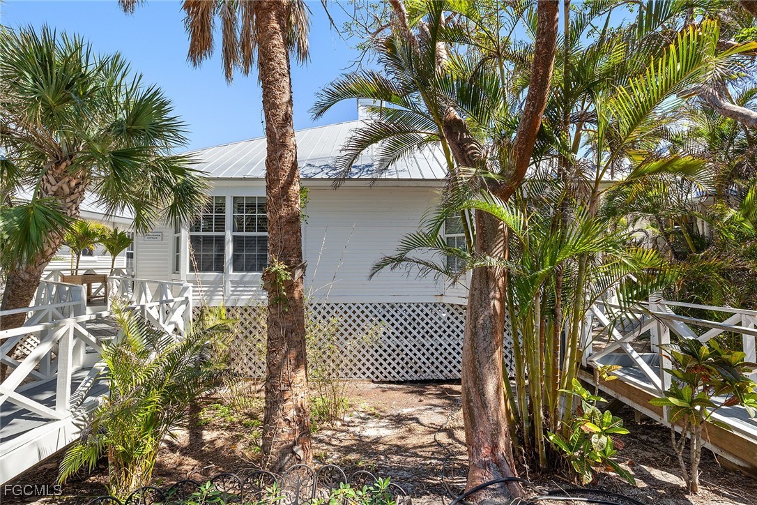 114 Useppa Island, Unit A Bokeelia, FL 33922 - Photo 4 of 44 front view of a house with a tree