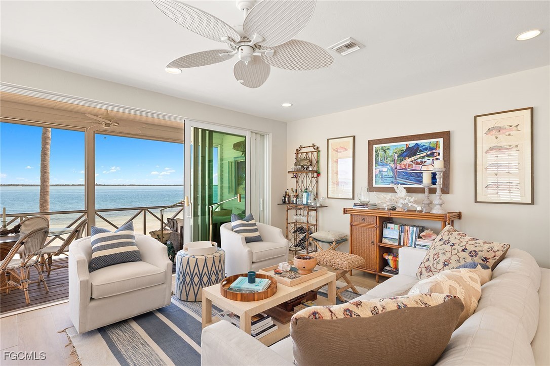 114 Useppa Island, Unit A Bokeelia, FL 33922 - Photo 5 of 44 a living room with furniture ceiling fan and a large window