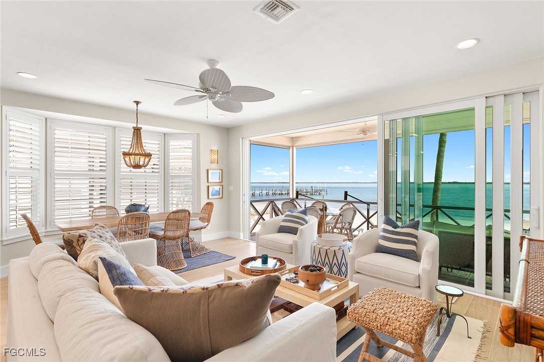 114 Useppa Island, Unit A Bokeelia, FL 33922 - Photo 6 of 44 a living room with furniture ceiling fan and a large window