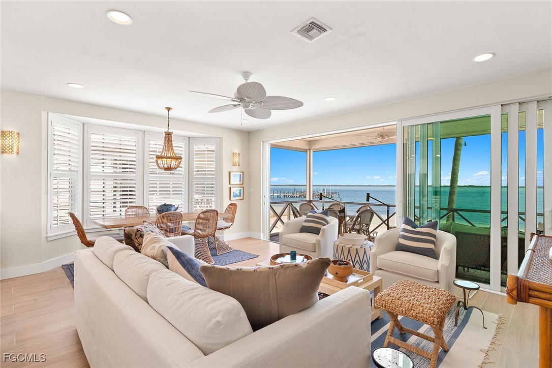 114 Useppa Island, Unit A Bokeelia, FL 33922 - Photo 7 of 44 a living room with furniture ceiling fan and a large window