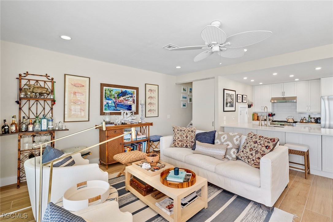 114 Useppa Island, Unit A Bokeelia, FL 33922 - Photo 9 of 44 a living room with furniture kitchen view and a table