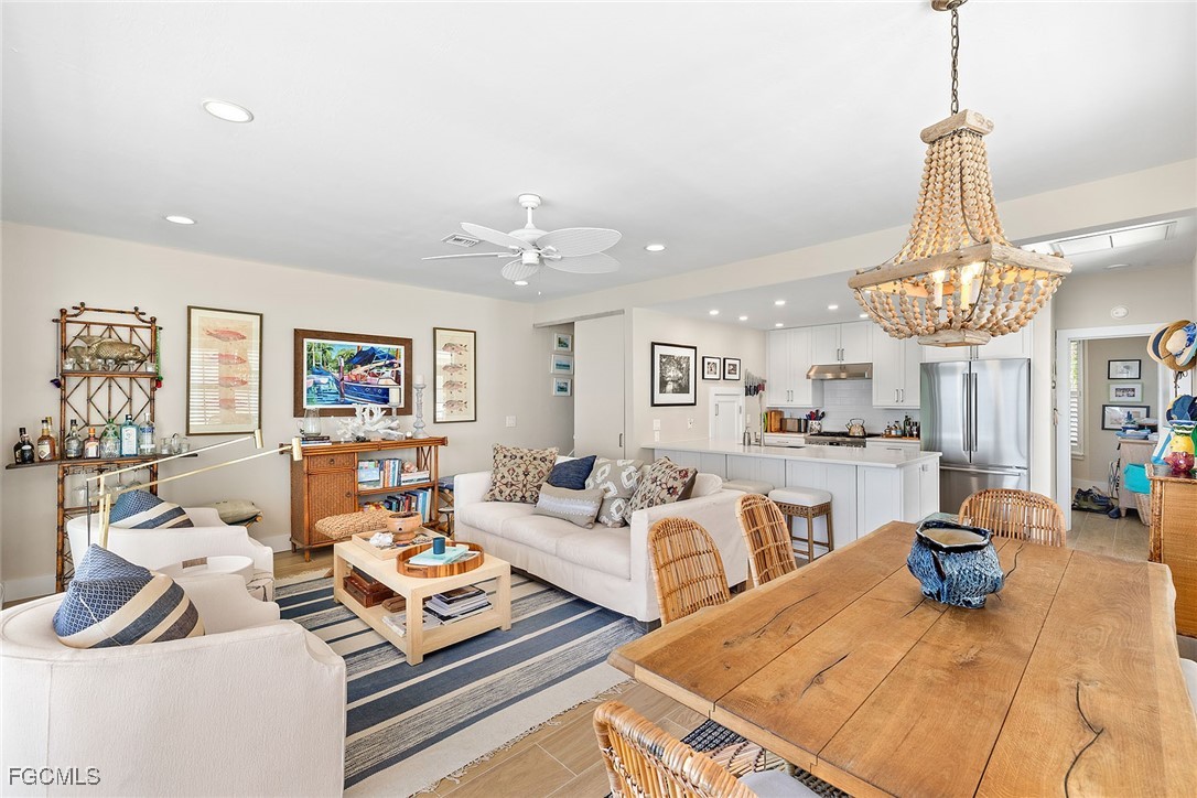 114 Useppa Island, Unit A Bokeelia, FL 33922 - Photo 10 of 44 a living room with lots of furniture and a chandelier