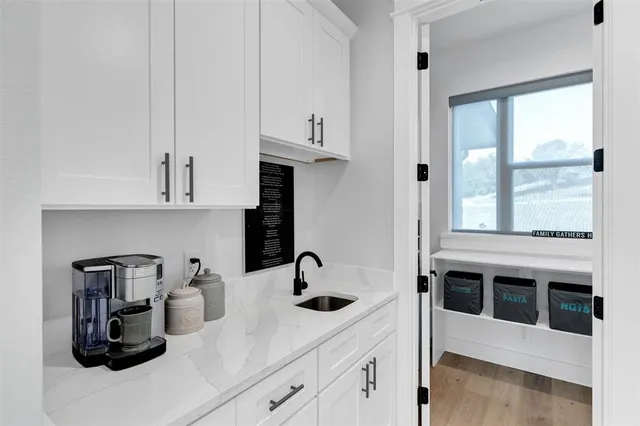 a kitchen with sink and cabinets