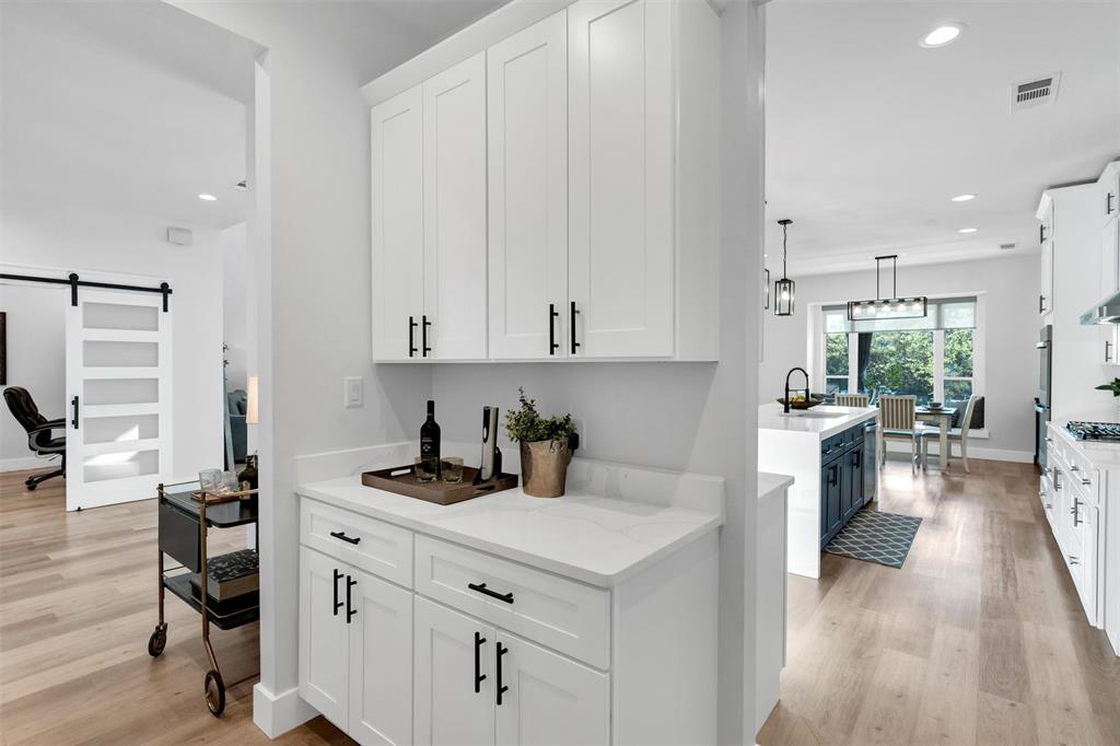 175 Bittersweet Trail Weatherford, TX 76088 - Photo 16 of 40 a kitchen with a sink cabinets and wooden floor