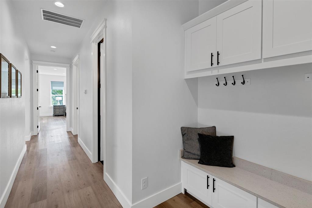 175 Bittersweet Trail Weatherford, TX 76088 - Photo 18 of 40 a view of a hallway with wooden floor and cabinet