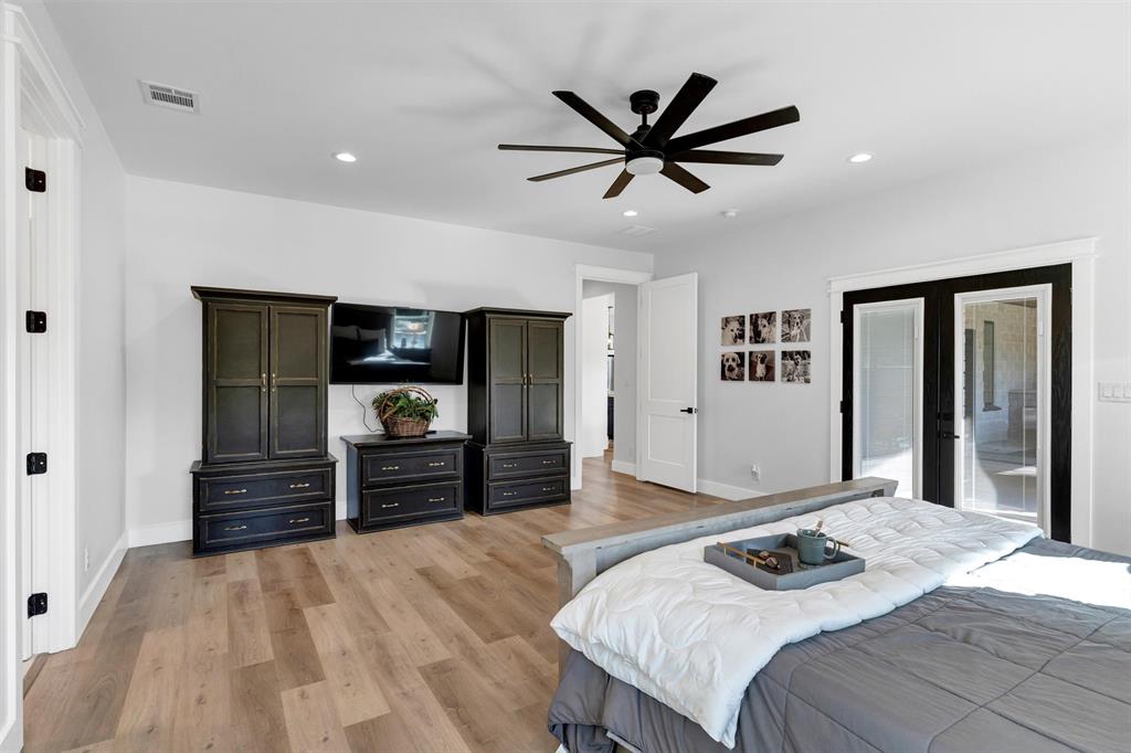 175 Bittersweet Trail Weatherford, TX 76088 - Photo 22 of 40 a bedroom with a bed and a television