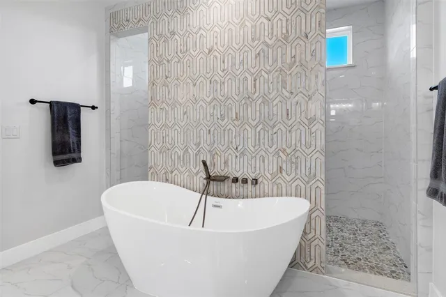 a white bath tub sitting in a bathroom