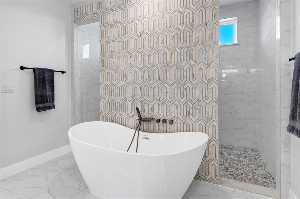 175 Bittersweet Trail Weatherford, TX 76088 - Photo 24 of 40 a white bath tub sitting in a bathroom