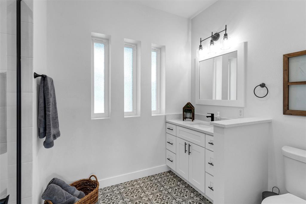 175 Bittersweet Trail Weatherford, TX 76088 - Photo 29 of 40 a bathroom with a double vanity sink toilet and mirror