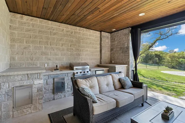 a living room with furniture and a floor to ceiling window