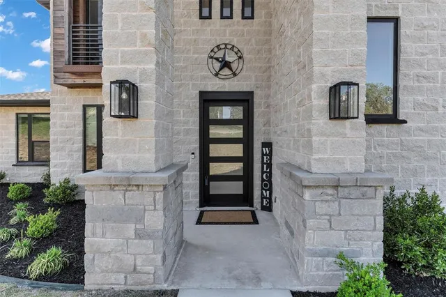 a front view of a building with potted plants