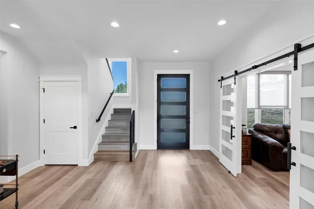 a view of a livingroom with wooden floor and stairs
