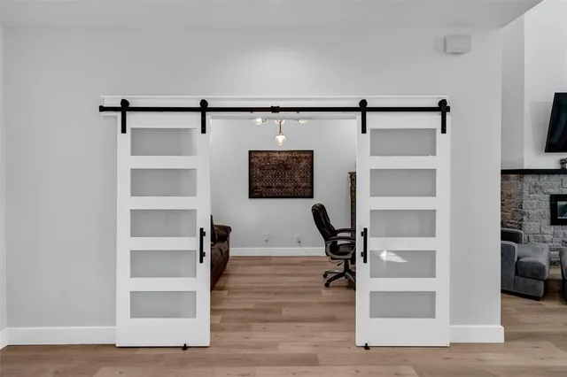 a view of a hallway with wooden floor and closet