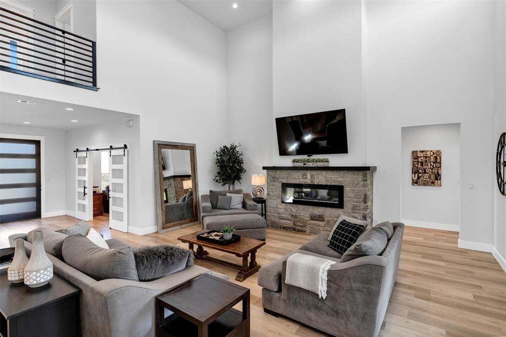 175 Bittersweet Trail Weatherford, TX 76088 - Photo 9 of 40 a living room with furniture a flat screen tv and a fireplace